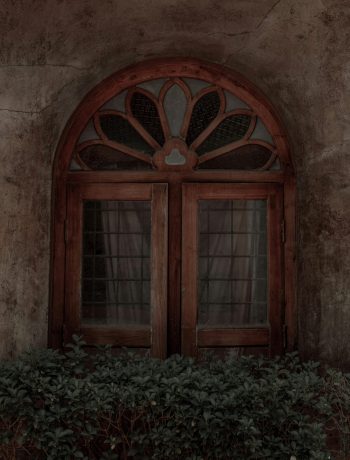 Charming wooden window with decorative arch in Kochi, India. Perfect for architectural and travel themes.